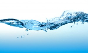 Close-up picture of abstract water wave with bubbles.